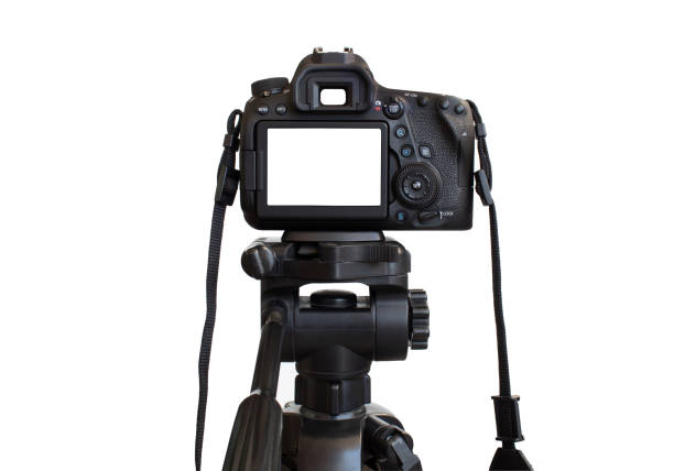 istock Dslr camera with white screen on the tripod isolated on white background. White screen camera 1390717688
