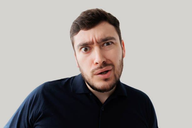 istock surprised man looks with a shocked expression 1390717858