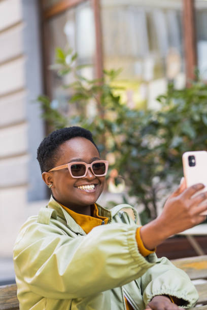 istock Beautiful black woman taking a selfie 1390721238
