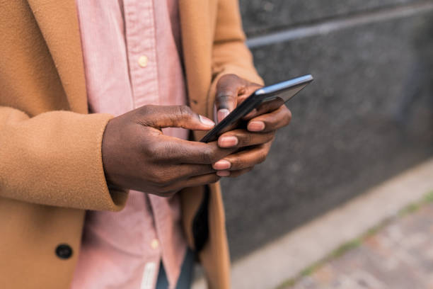 istock Close up shot of a black businessman using smart phone texting 1390721509