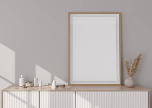 istock Empty vertical picture frame standing on console in modern room. Mock up interior in contemporary style. Free, copy space for picture. Pampas grass in vase. 3D rendering. 1390722291