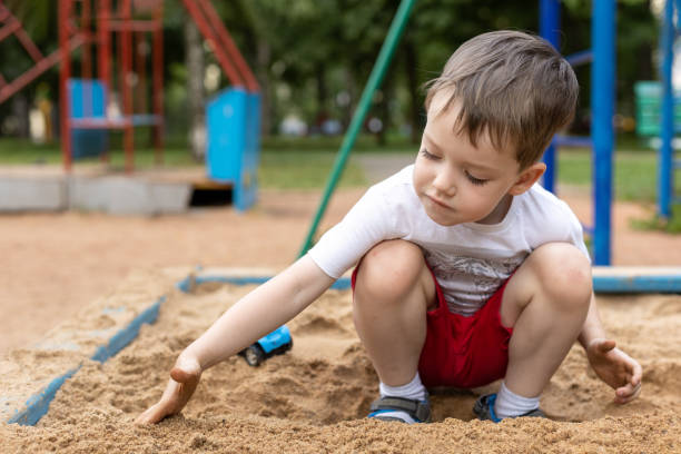 istock Outdoors portrait of a 4 year old boy playing on a playground 1390723515