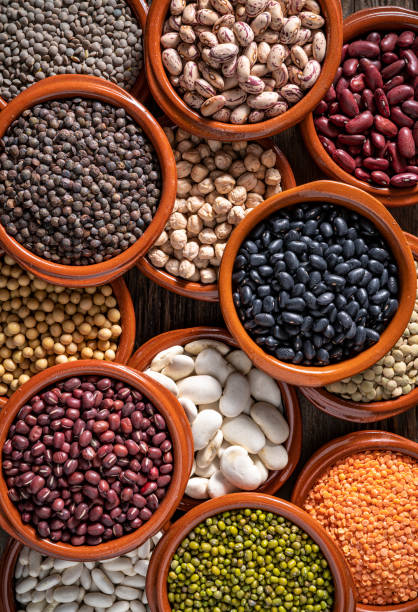 istock Assorted legumes in round clay containers on rustic wooden background 1390724743