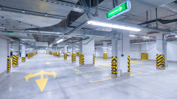 istock Empty shopping mall underground parking lot or garage interior with concrete stripe painted columns 1390735043