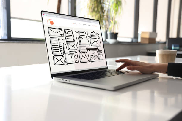 istock Woman using laptop with envelope icons 1390735710