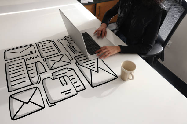 istock Woman using laptop with envelope icons 1390735725