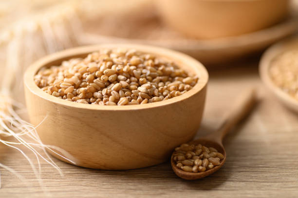 istock Whole wheat grain in wooden bowl 1390736623