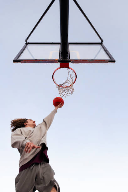 istock man playing in a basketball hoop seen from below 1390738975