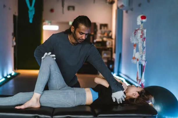 Photo of Professional Indian male providing sports physio for his client