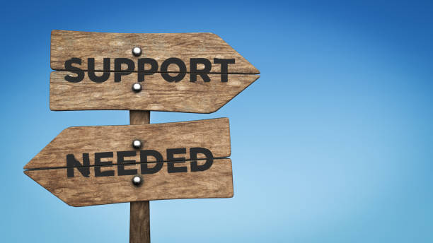 istock Wooden road signs and support needed text. 1390777149