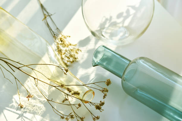 istock Glassware vase reflect sunlight shadow effect, Summer still life scene, Transparent glittering bottle glasses of water, Warm light vibe in sunny day. 1390777213