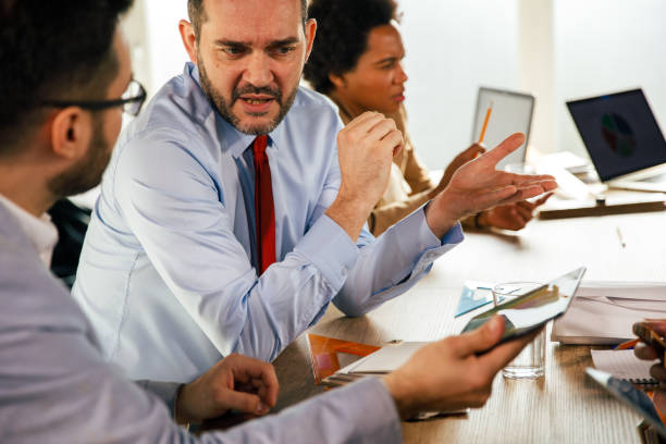 istock Businessmen reviewing data on digital tablet, strategizing and discussing ideas 1390778212