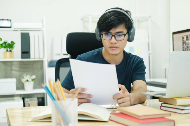 istock Young man study in front of the laptop computer at home 1390782503
