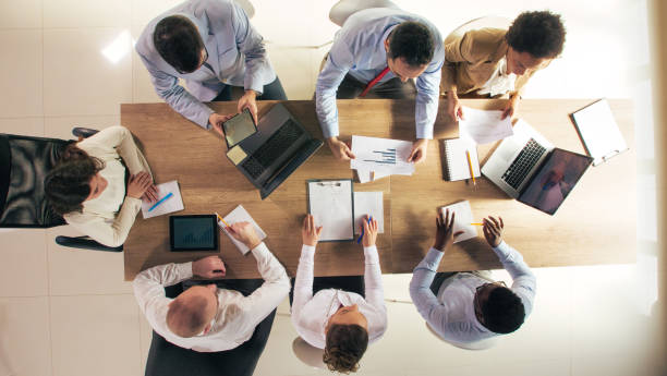 istock Entrepreneurs having a business meeting, reviewing documents and strategizing 1390783545