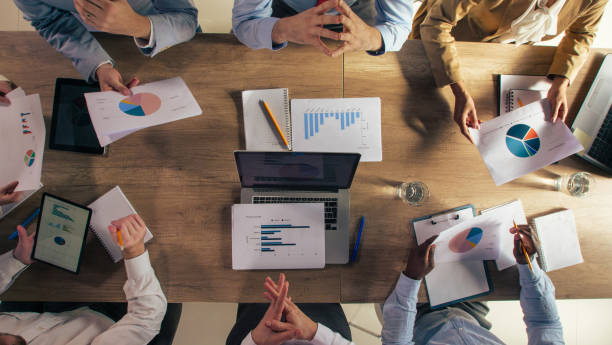 istock Diverse group of business people analyzing various charts and graphs during a meeting 1390783560