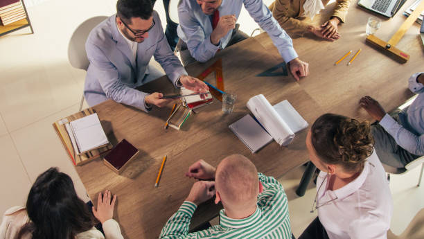 istock Directly above architects and entrepreneurs strategizing during a meeting 1390783561