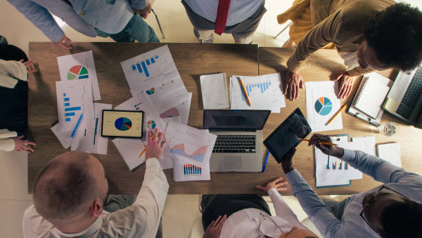 istock Business people strategizing during a meeting while reviewing charts and graphs 1390783564