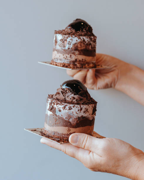 istock Mini chocolate cakes, Chocolate Mousse Cakes, holding mini chocolate cakes, 1390784241