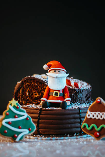 christmas decorated cake and cookies, santa claus and christmas tree cookies, chocolate christmas cake, merry christmas celebration cake, new year's celebration cake