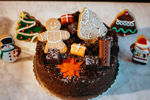 christmas decorated cake and cookies, santa claus and christmas tree cookies, chocolate christmas cake, merry christmas celebration cake, new year's celebration cake