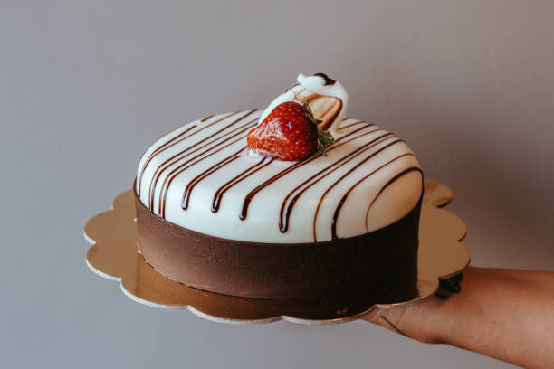 istock Chocolate cake topped with a strawberry,Chocolate Cake Isolated on White, chocolates cake,Black Forest Cake, circle chocolate cakes, holding the cake 1390784550