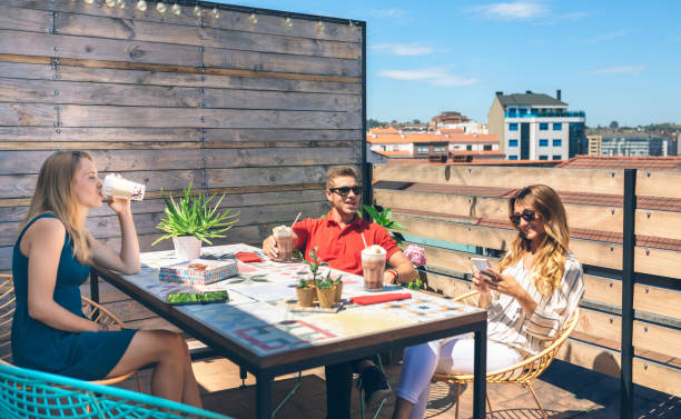 istock Happy friends having a drink on a terrace 1390786390