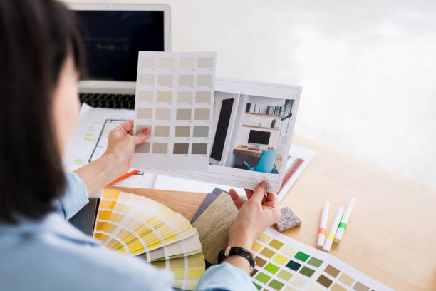 istock Woman architect working on interior renovation. Designer choosing color samples according to the visualization of the project. Architecture and interior design concept. 1390787573