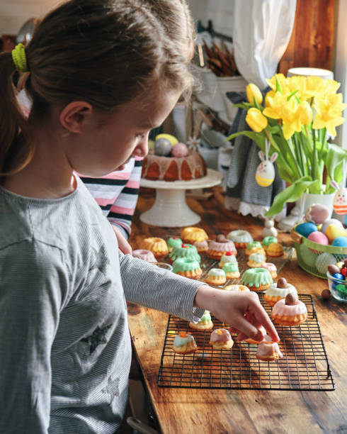 Two Girls Decorating Small Bundt Cakes with Sweets