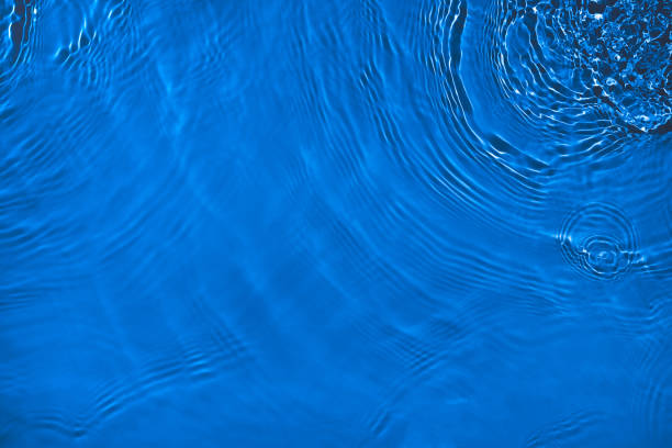 istock transparent dark blue colored clear calm water surface texture 1390790899