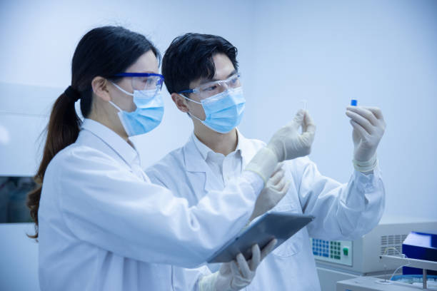 istock Female and male scientists working in a laboratory 1390791275