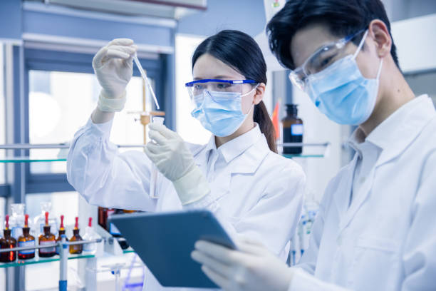 istock Asian scientists working in a medical laboratory 1390792629