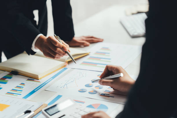 istock Business team analyzing income charts and graphs with modern laptop computer. Close up.Business analysis and strategy concept. 1390792790