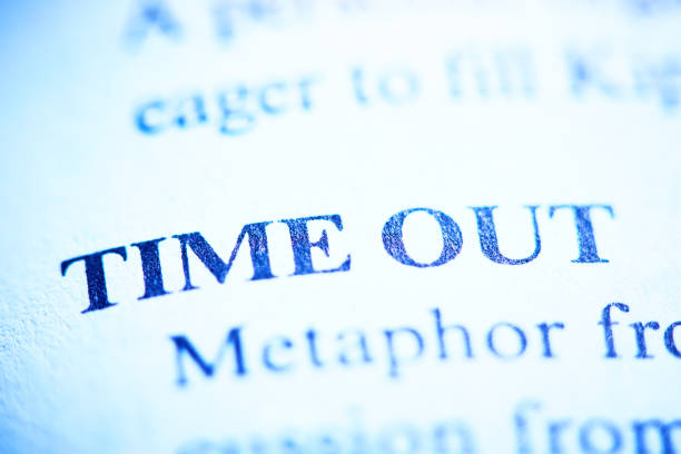 Close-up of the bold term TIME OUT in tight close-up shot of an entry in a business dictionary.