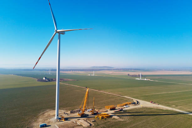 istock Construction site near windmill turbine, Wind generator installing 1390794180
