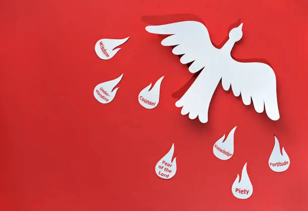 the holy spirit in the form of a white dove carries seven gifts, the flames of the gifts of the holy spirit