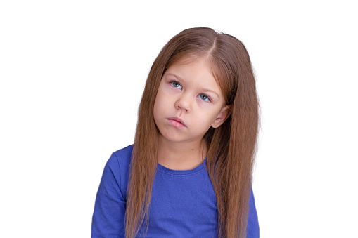 Isolated waist up caucasian puzzled thinking sad child kid little girl of 5 years in blue on white background looking up