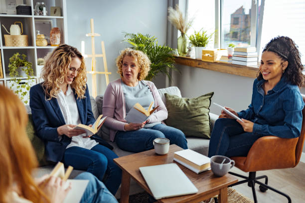 istock Group of young and mature people studying or reading books. 1390797865