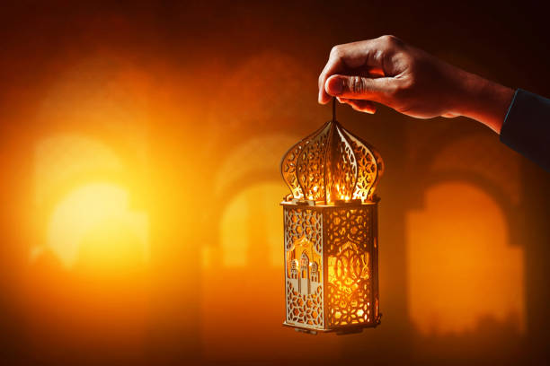 istock Muslim man holding arabic lantern 1390799084