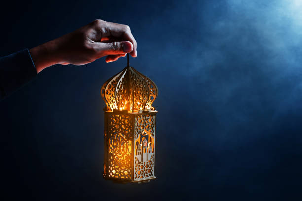 istock Muslim man holding arabic lantern 1390799092