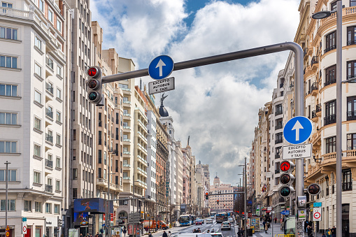 Madrid, Spain. March 7 2022. Buildings and traffic in gran vía street, Madrid. Mid-day with clouds and clearings