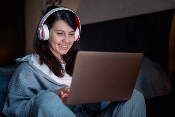 istock woman in headset working on laptop has video call 1390800488