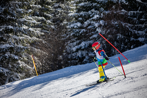 Boy is traversing down the slope at a ski competition