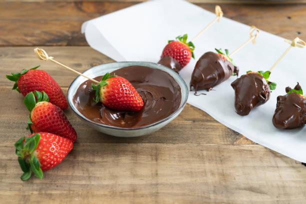 istock Strawberries with chocolate. Strawberries dipping process in chocolate. Copy space. 1390801983