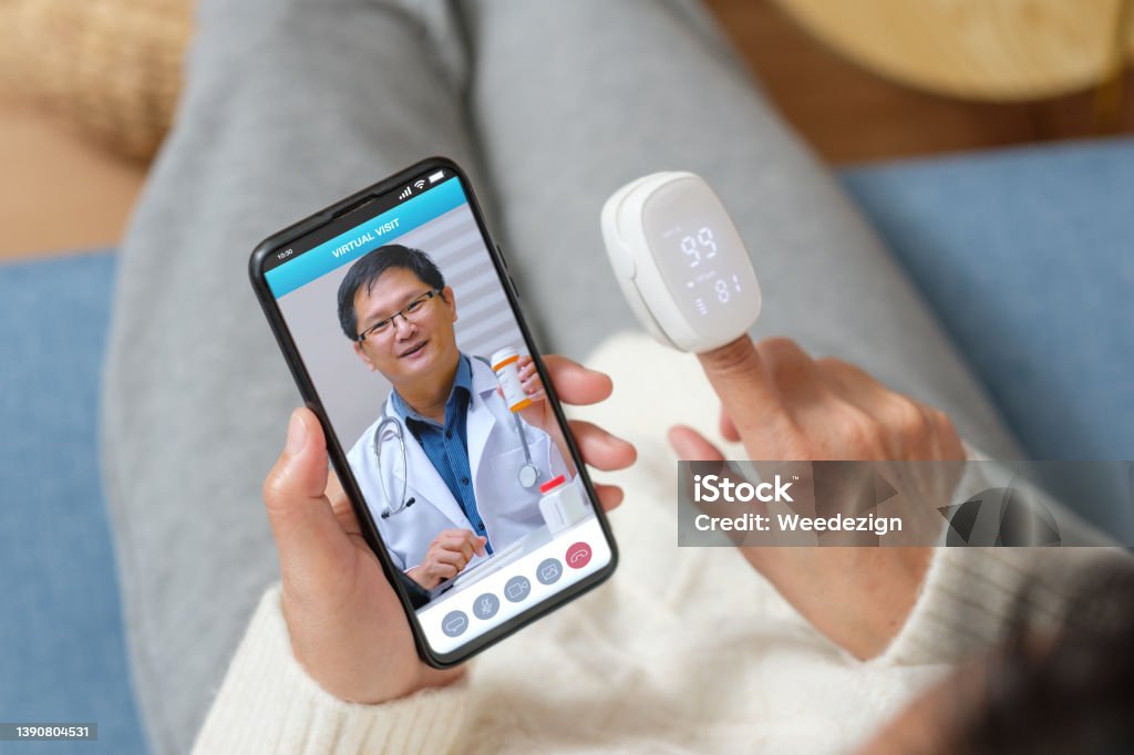 Consulting doctor visit on mobile app at home.telemedicine Telemedicine Stock Photo