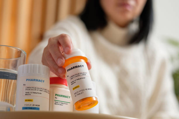 istock asian woman taking pill when get sick at home 1390804563