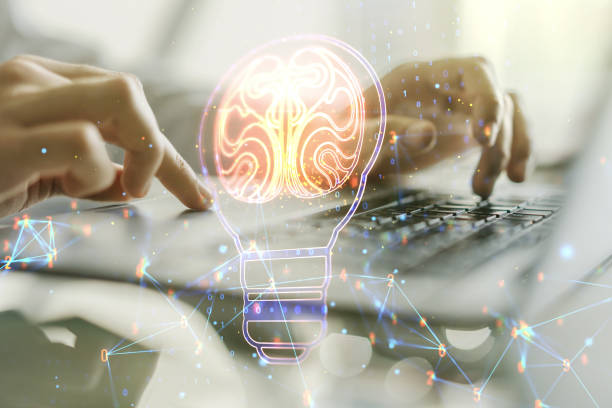 istock Double exposure of creative light bulb hologram with human brain and with hands typing on laptop on background, idea and brainstorming concept 1390804896