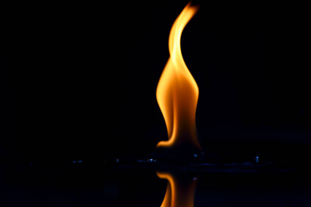 istock Burning yellow flame isolated on black 1390807504
