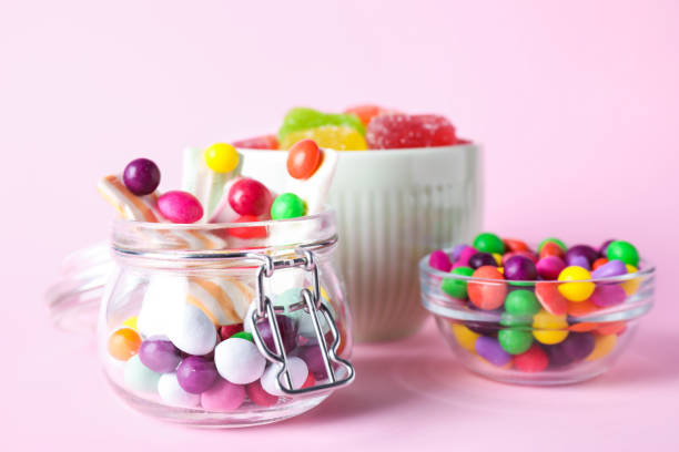 istock Many different yummy candies on pink background 1390808054