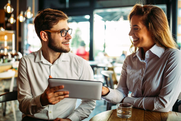 istock Two young colleagues chatting together on a break 1390809352