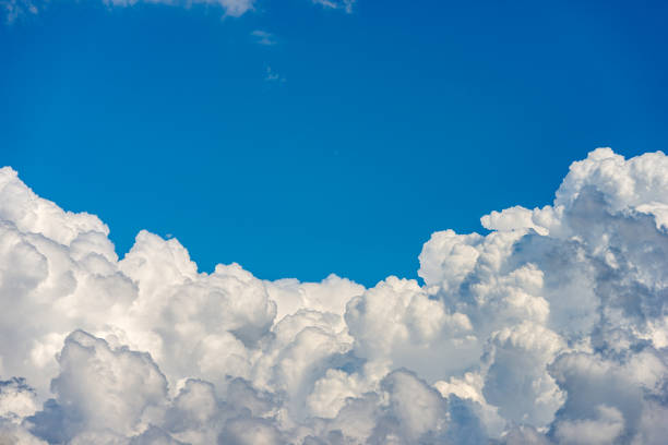 Beautiful storm clouds, cumulus clouds or cumulonimbus against a clear blue sky. Photography, Full frame.